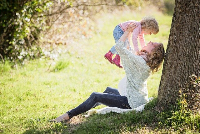 子どもを抱き上げるママ